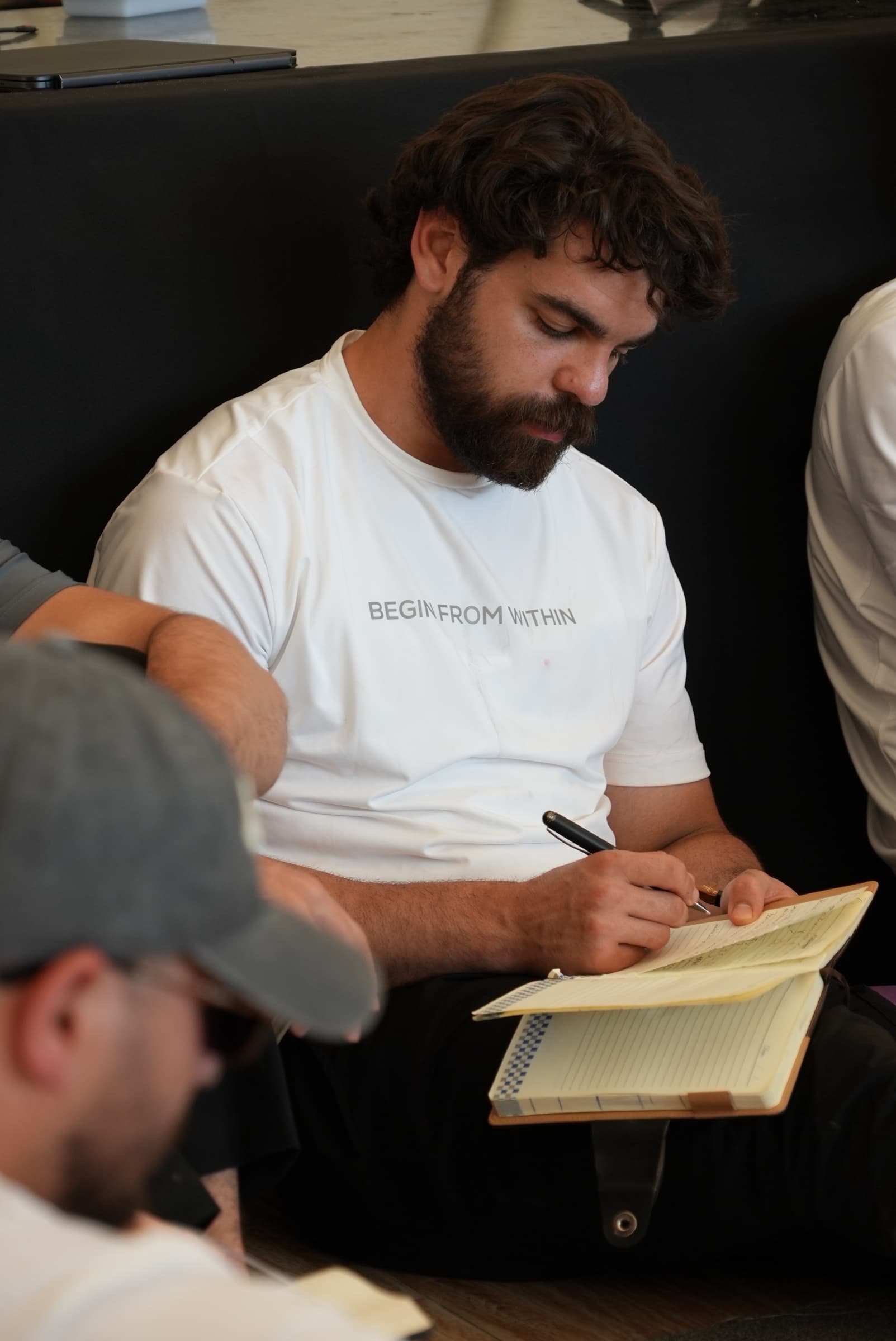 Leadership bootcamp participant writing notes during a reflective session