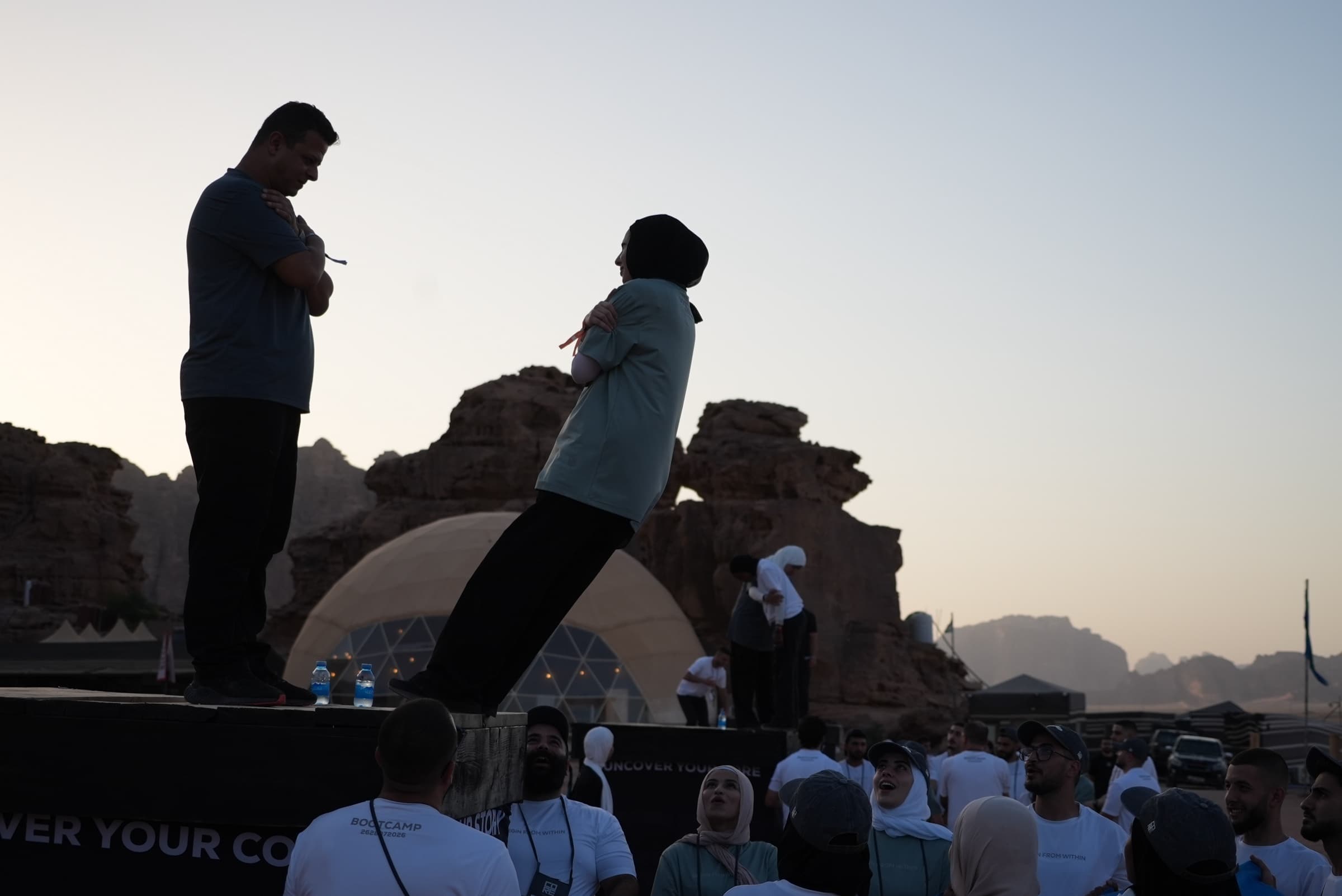 Leadership bootcamp participants practicing a trust exercise in Wadi Rum